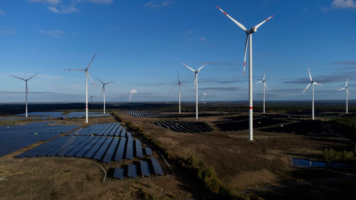 Wind turbines spin at the Klettwitz Nord solar energy park near Klettwitz, Germany.