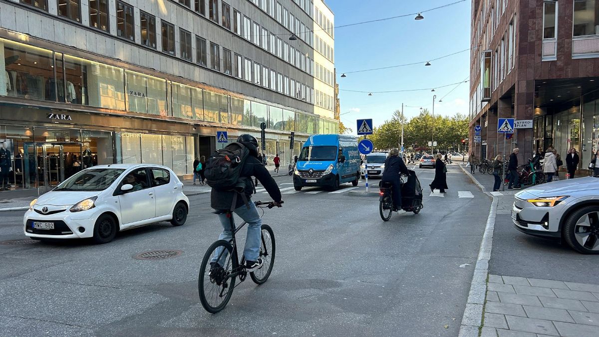 Cars drive on a road in the city centre in Stockholm, Sweden, October 2023.