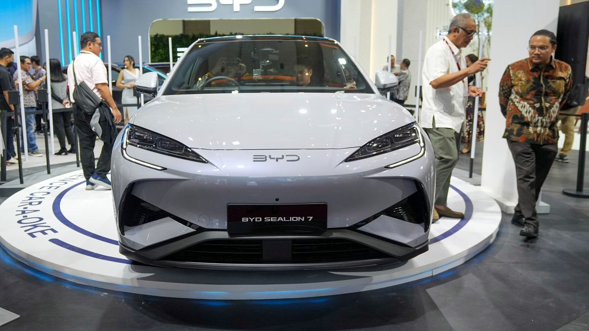 Visitors examine a BYD booth during the Indonesian International Motor Show in Jakarta, Indonesia, Thursday, Feb. 13, 2025.