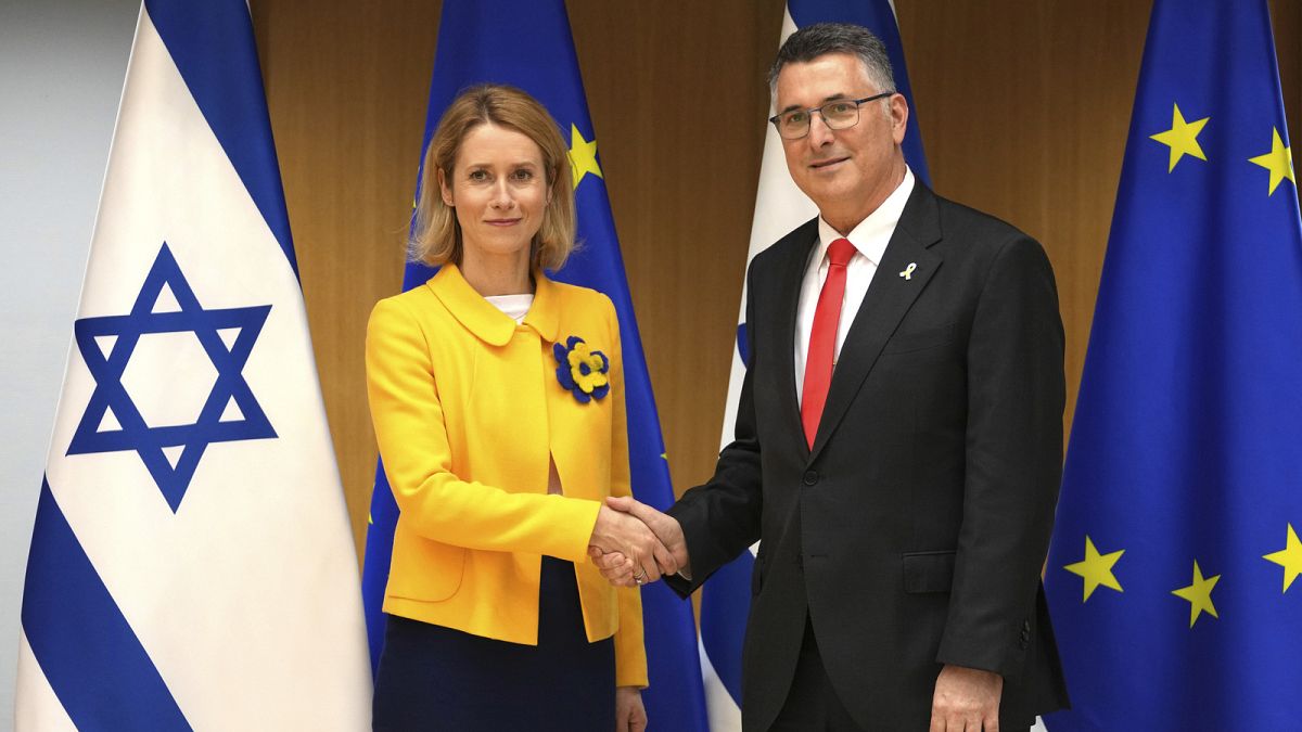 European Union foreign policy chief Kaja Kallas, left, shakes hands with Israel