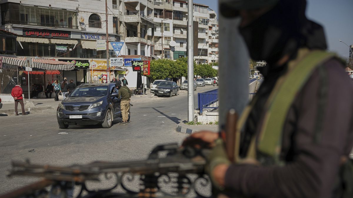 Syrian security forces inspect vehicles at a checkpoint following a wave of violence with gunmen loyal to former President Bashar al-Assad in Latakia, 11 March, 2025