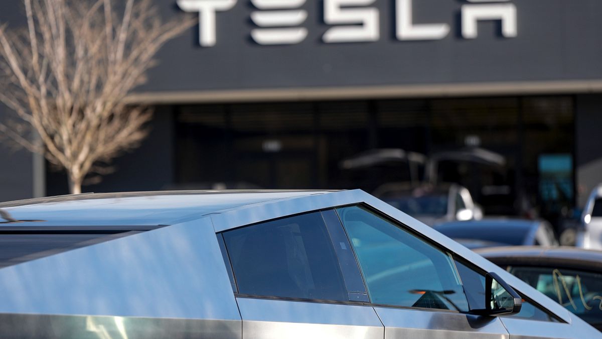 A Tesla Cybertruck and other Telsla vehicles sit at a dealership, Wednesday, March 19, 2025, in Kennesaw, Ga