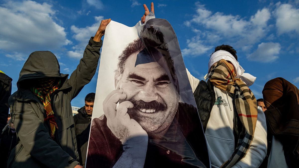 Youngsters hold a photograph of PKK