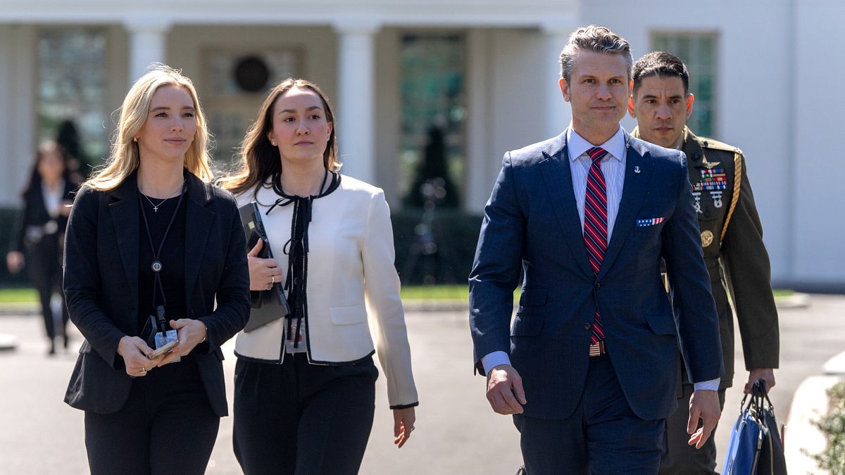 Defence Secretary Pete Hegseth, second from right, walks outside the White House on 21 March, 2025.