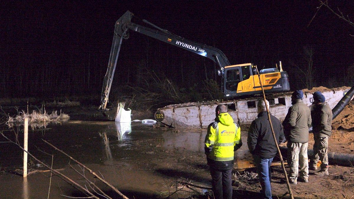 Emergency services build a makeshift dam from HESCO barrier bags during recovery efforts for four US soldiers in Lithuania, 27 March, 2025