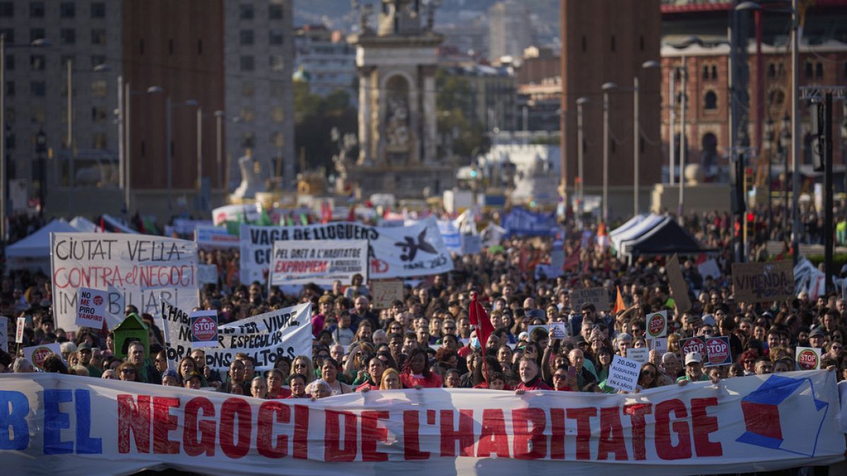 People gather during a demonstration to protest high housing costs in Barcelona, Spain, Saturday, April 5, 2025.