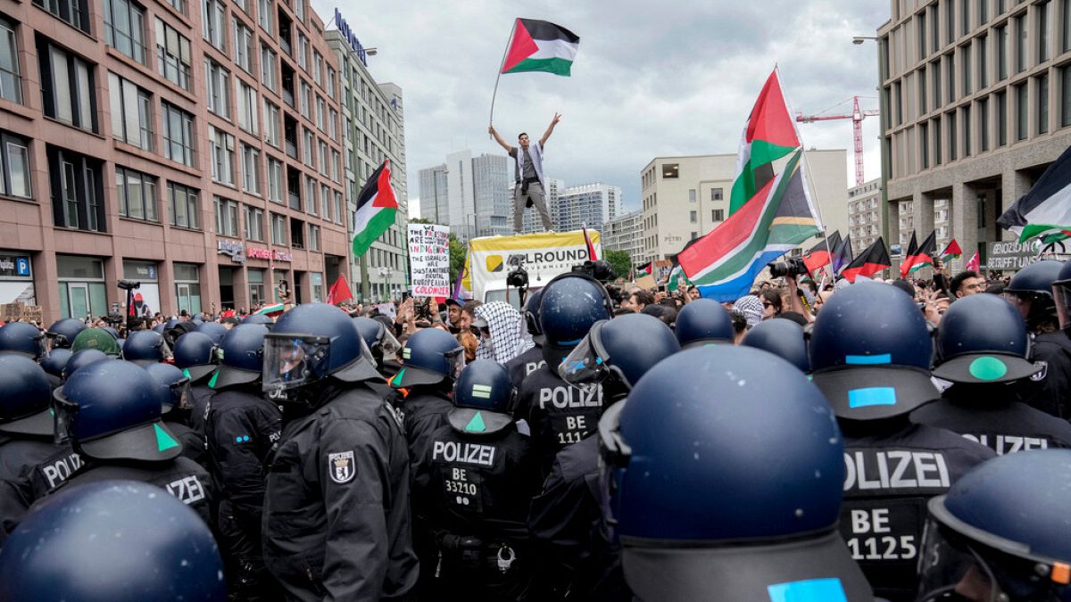 Police officers try to stop people taking part in a pro-Palestinian rally in Berlin, Saturday, May 18, 2024.