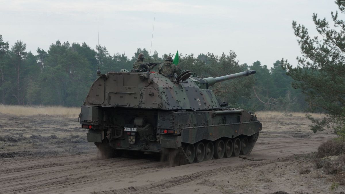 Two soldiers of the Artillery Battalion 345 of the 10th armoured division on a 2000 self-propelled howitzer.
