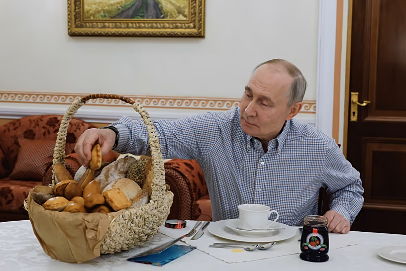 DATEI – Der russische Präsident Wladimir Putin probiert Gebäck aus der Bäckerei Mashenka in Moskau, 20. Dezember 2025